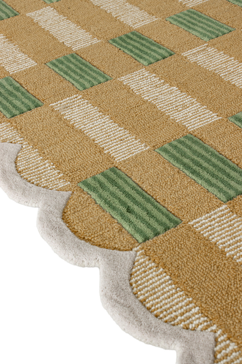 Close-up of a checkered patterned rug with green and beige colors.