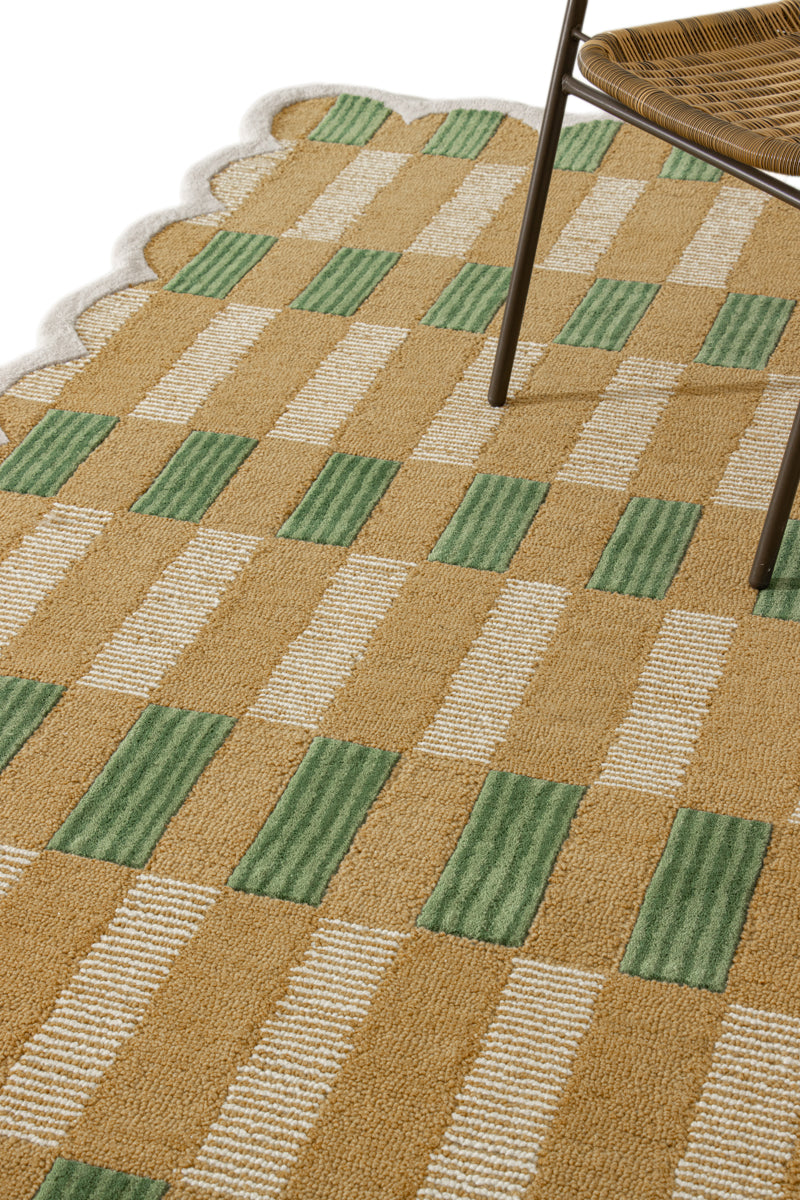 Checkered patterned rug with green and beige squares on a white background