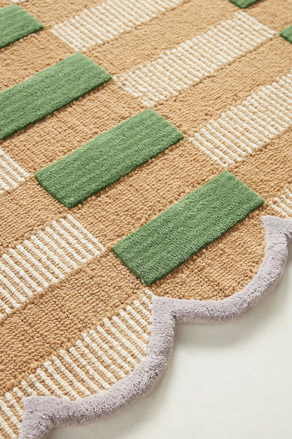 Rug with green and beige checkered pattern on a white background
