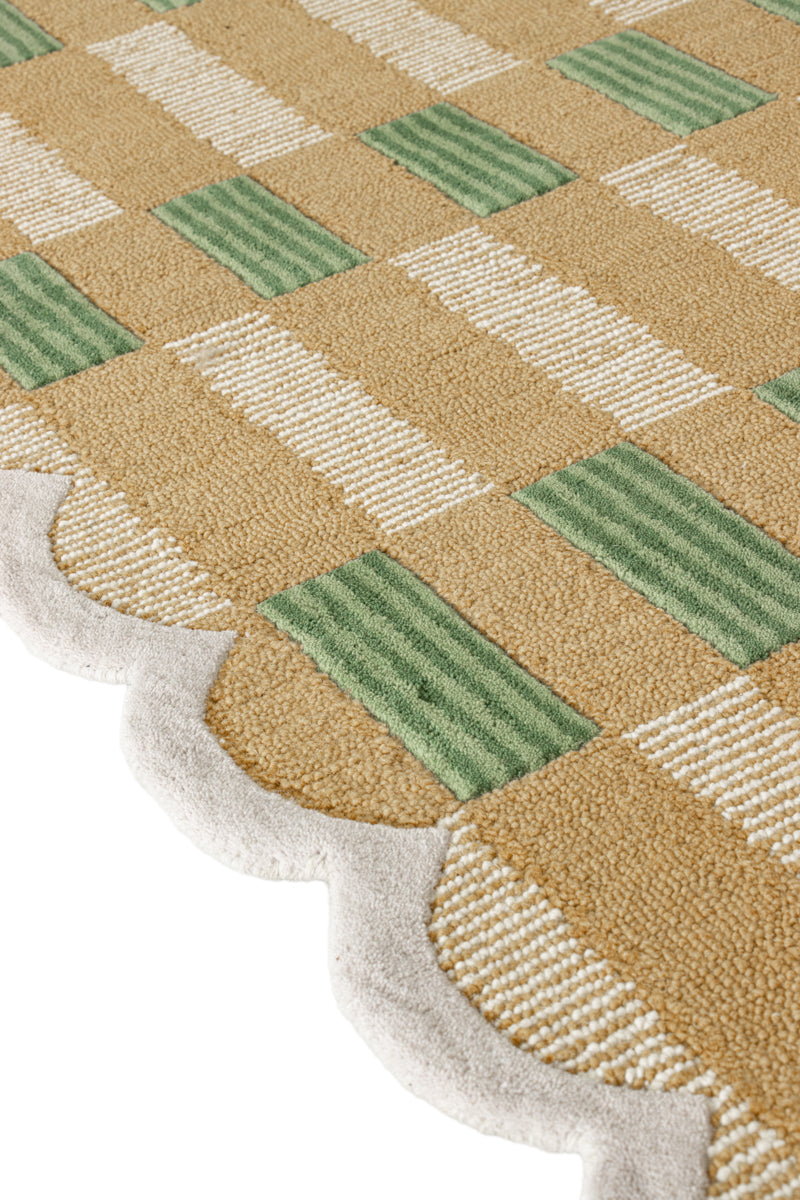 Close-up of a checkered patterned rug with green and beige colors.